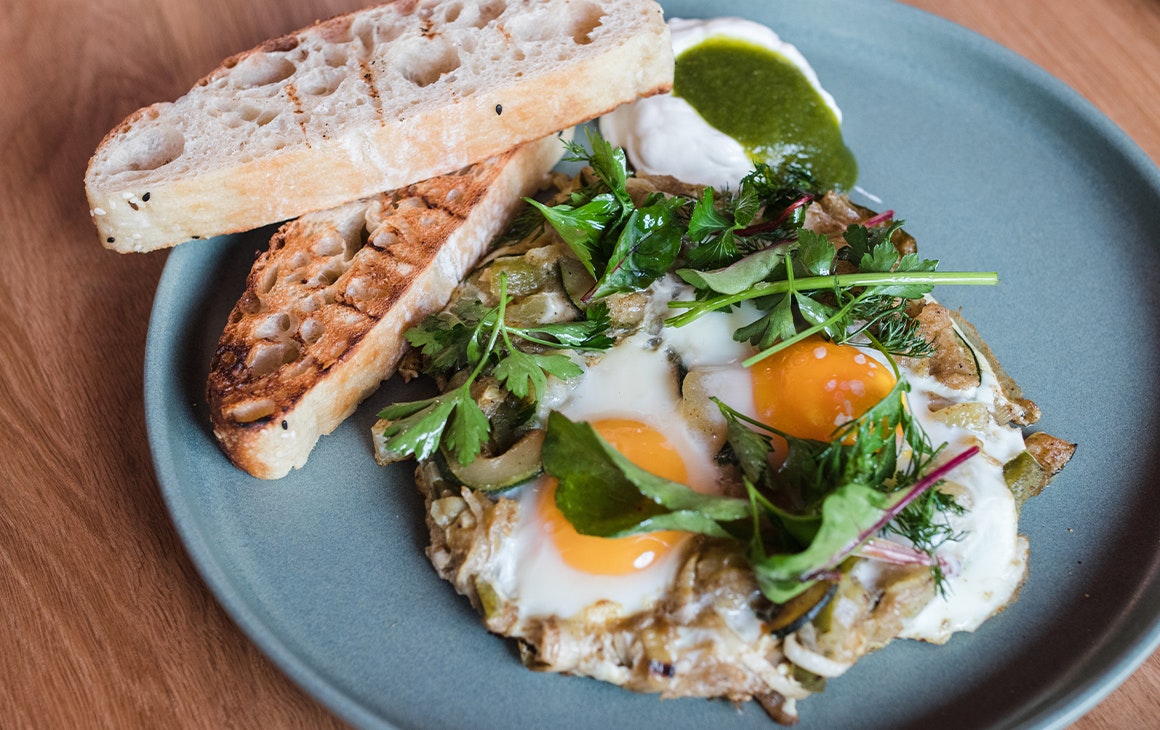 a plate of shakshuka with turkish bread